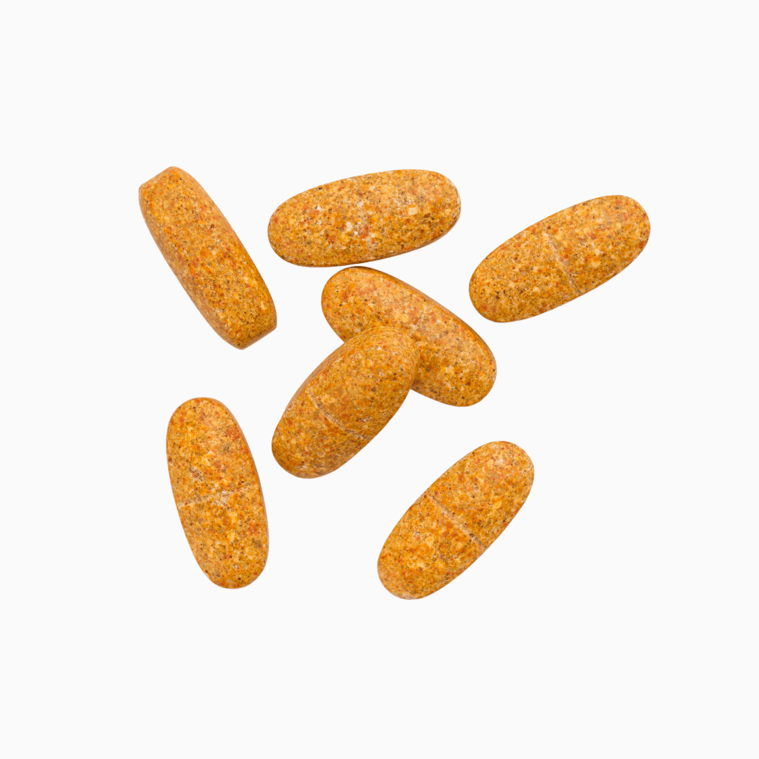 Six oval orange-yellow supplement capsules of Orenda Active scattered on a plain white background 