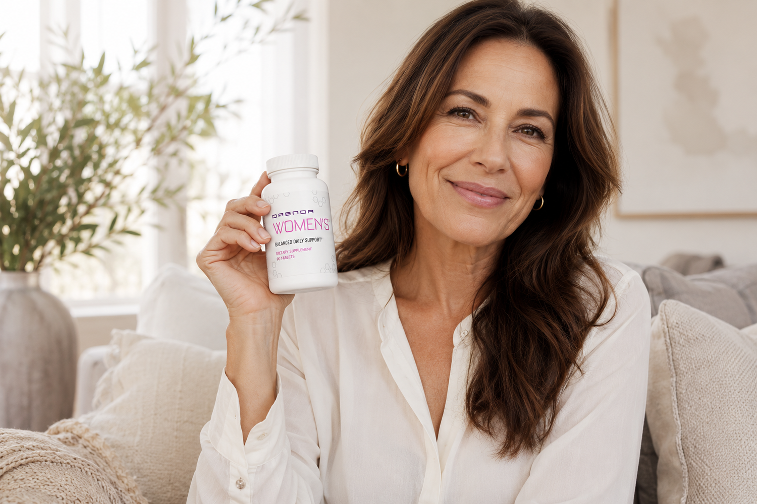 Woman holding supplement bottle